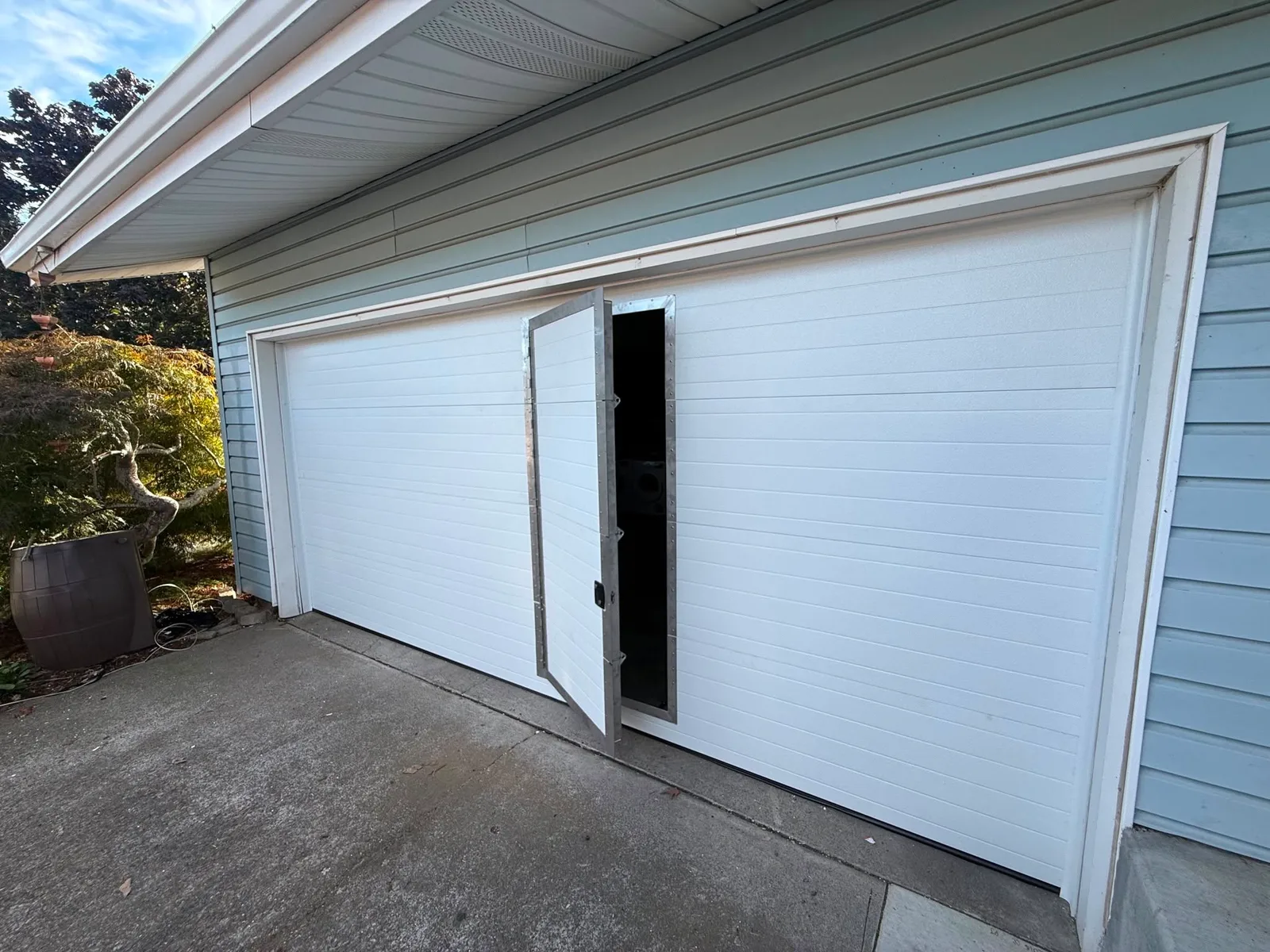The completed Portland garage door with the pedestrian door open