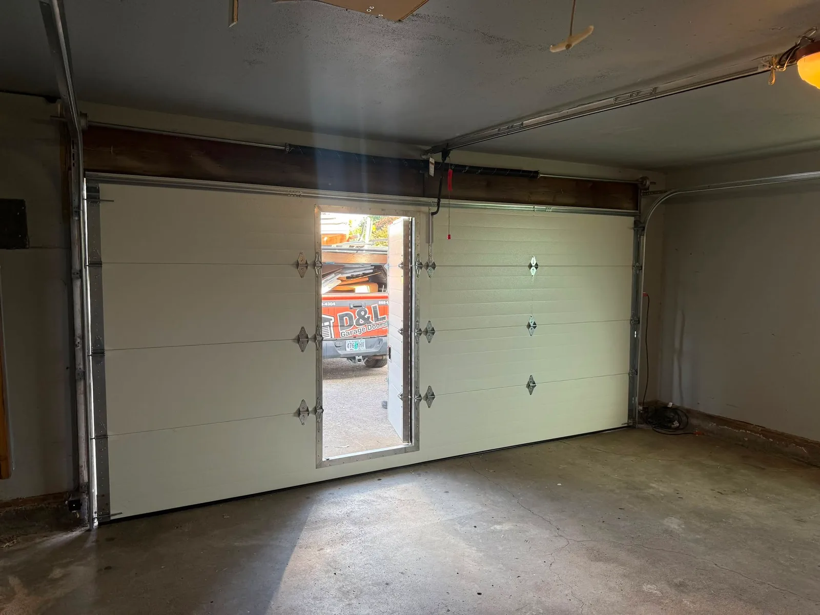 Interior view of the completed garage door with its pass door open